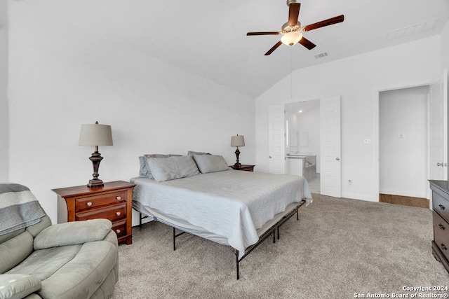 carpeted bedroom with ceiling fan, connected bathroom, and vaulted ceiling