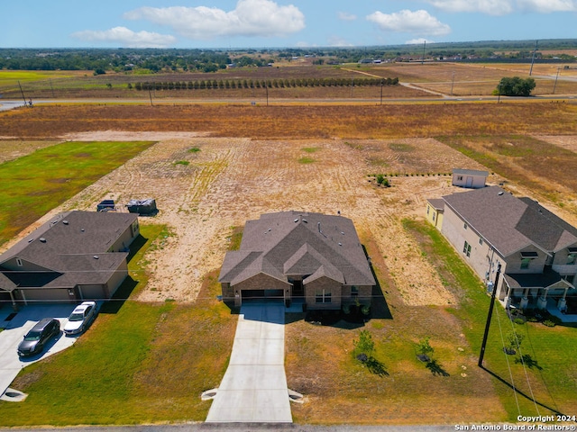 birds eye view of property with a rural view