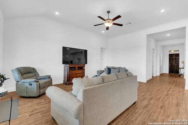 living room with light wood-type flooring, ornamental molding, and ceiling fan