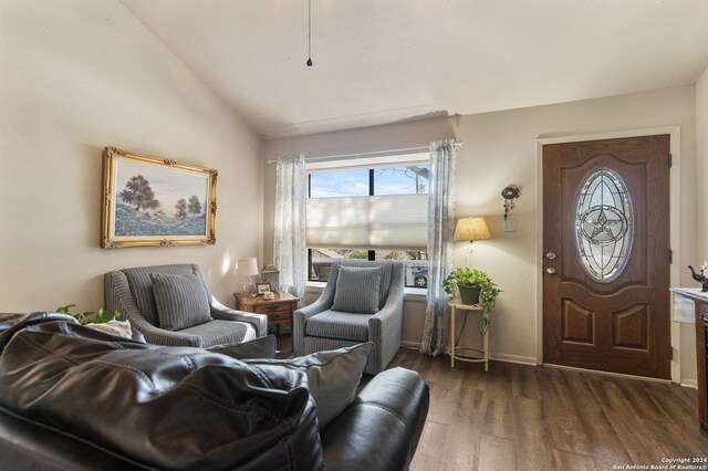 living room with vaulted ceiling and dark hardwood / wood-style flooring