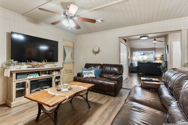 living room featuring ceiling fan, wooden walls, hardwood / wood-style floors, and wooden ceiling