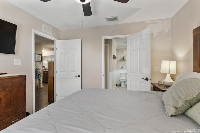 bedroom featuring hardwood / wood-style floors, ceiling fan, and ensuite bathroom