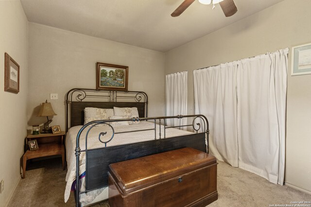 bedroom with ceiling fan and light carpet