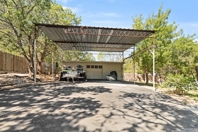 view of parking featuring a carport and a garage