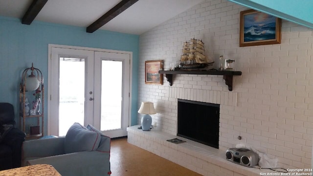 living room featuring a brick fireplace, vaulted ceiling with beams, brick wall, and french doors