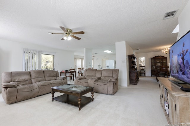 carpeted living room with a textured ceiling and ceiling fan