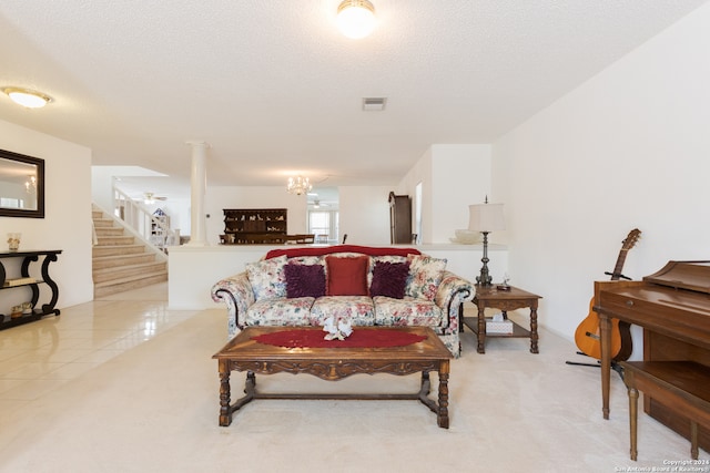 carpeted living room featuring a textured ceiling and an inviting chandelier