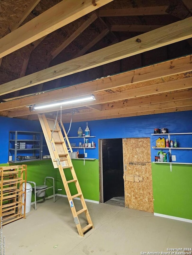 interior space with concrete flooring and vaulted ceiling