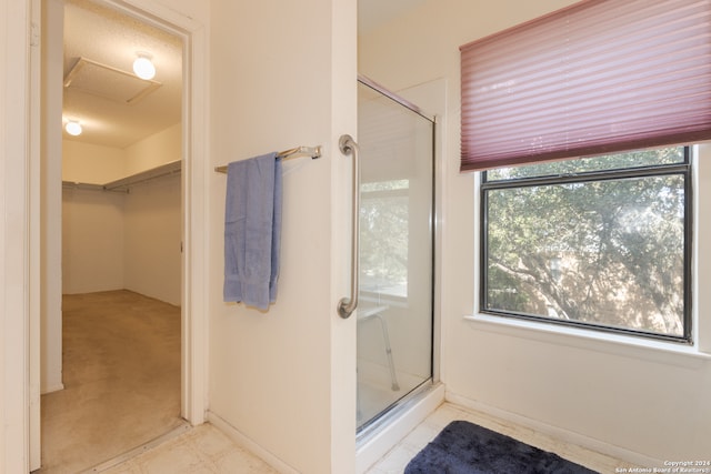 bathroom featuring a shower with shower door