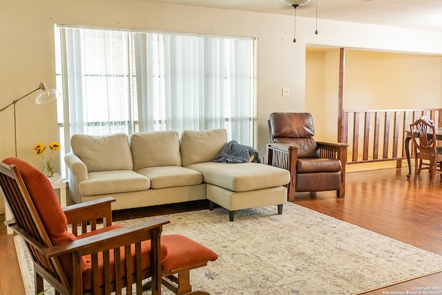 living room with ceiling fan and hardwood / wood-style floors