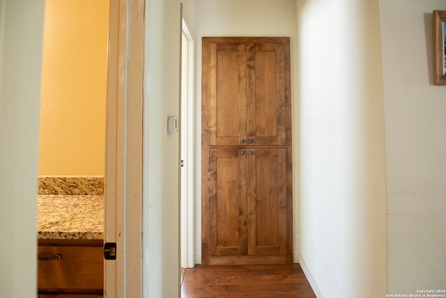 hall with dark wood-type flooring