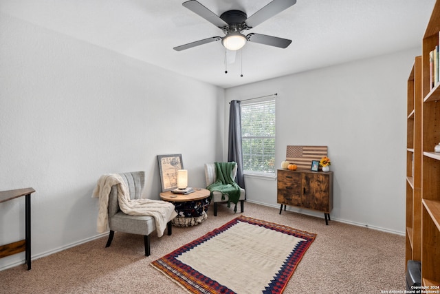 sitting room with ceiling fan and light carpet