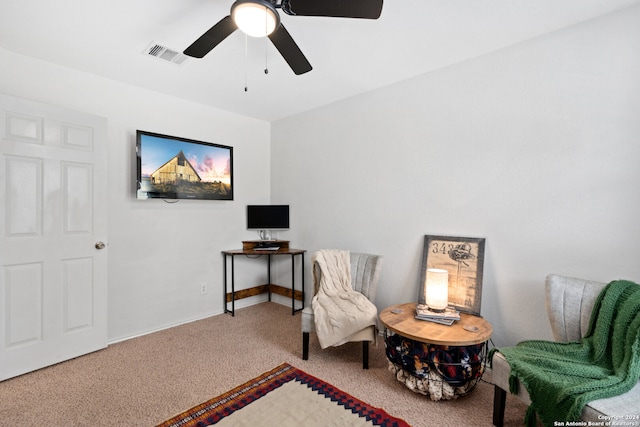 living area featuring ceiling fan and carpet flooring