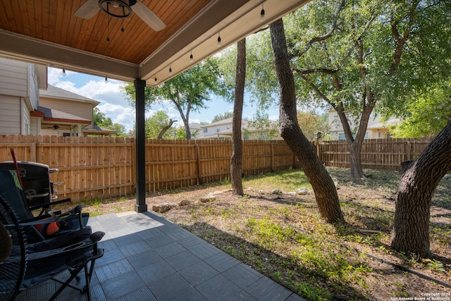 view of yard with ceiling fan and a patio area