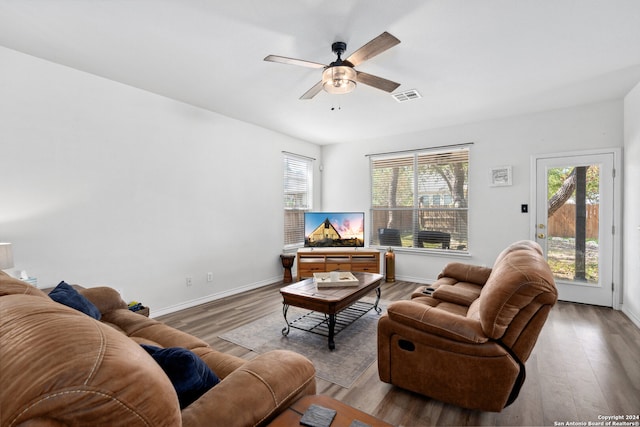 living room featuring light hardwood / wood-style flooring and ceiling fan