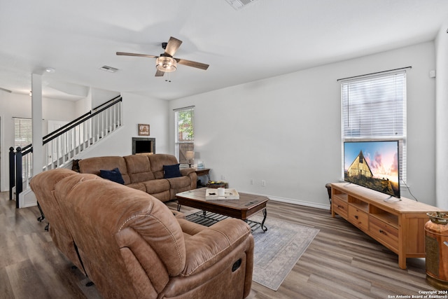 living room featuring ceiling fan and hardwood / wood-style flooring