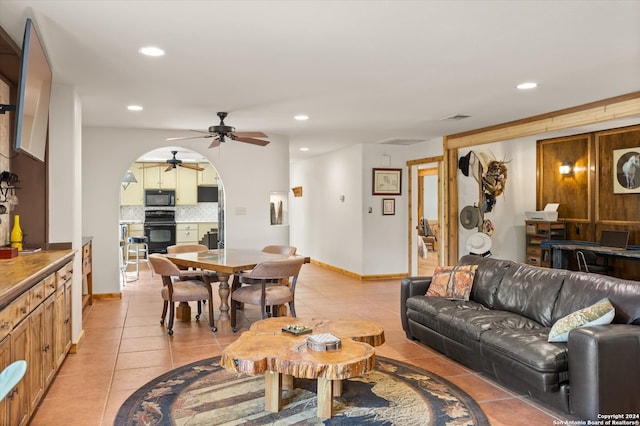 living room featuring ceiling fan and light tile patterned flooring