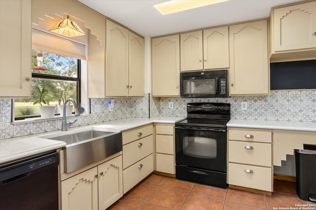 kitchen featuring black appliances, cream cabinets, and tile patterned floors