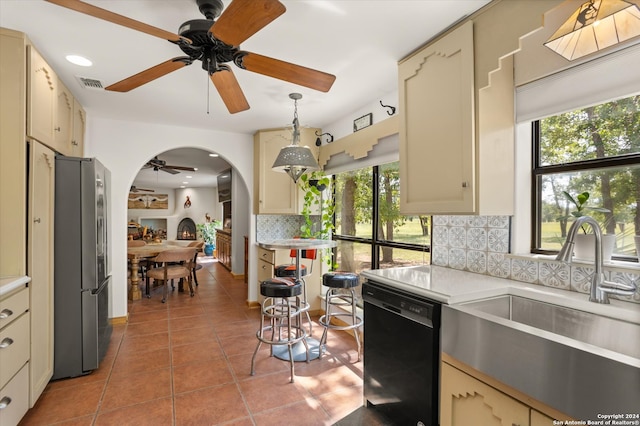 kitchen with ceiling fan and cream cabinets