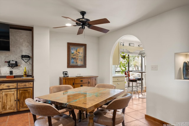 dining space featuring ceiling fan and light tile patterned floors