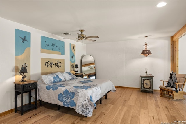 bedroom with wood-type flooring and ceiling fan