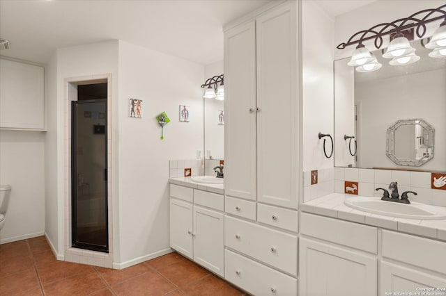 bathroom with vanity, an enclosed shower, tile patterned floors, toilet, and decorative backsplash