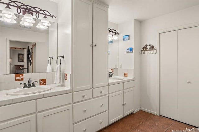 bathroom featuring tile patterned flooring, backsplash, and vanity