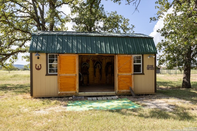 view of outbuilding featuring a lawn