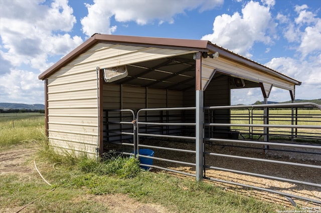 view of horse barn featuring a rural view