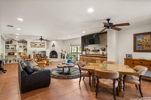 tiled dining room featuring ceiling fan and built in features