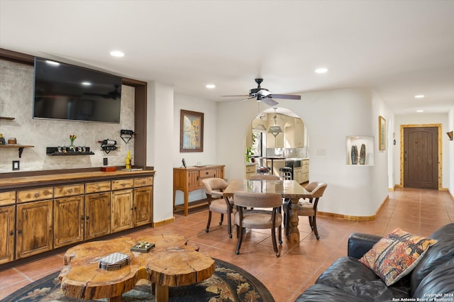 tiled living room featuring ceiling fan