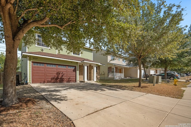 front facade with covered porch and a garage