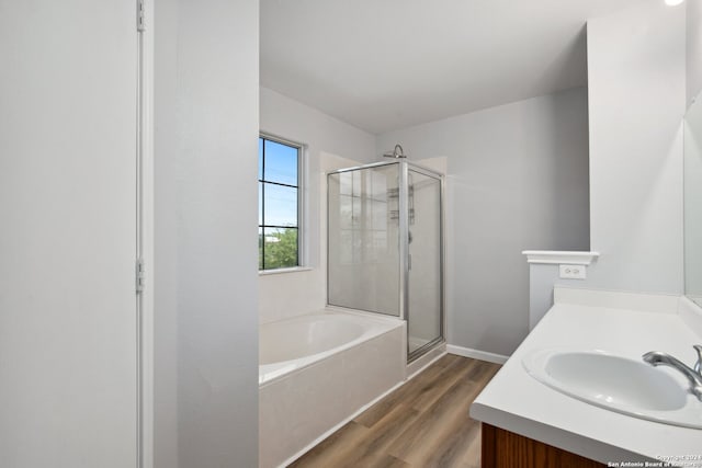 bathroom with vanity, plus walk in shower, and wood-type flooring