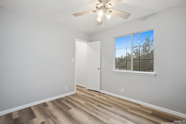 empty room featuring ceiling fan and hardwood / wood-style floors