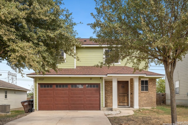 view of front of house featuring central AC and a garage