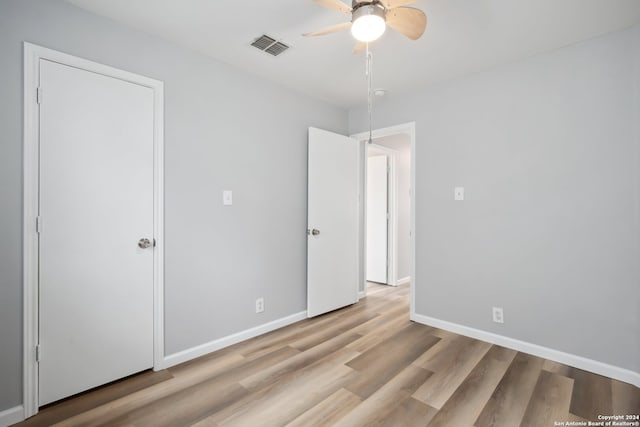 unfurnished bedroom featuring light hardwood / wood-style floors and ceiling fan