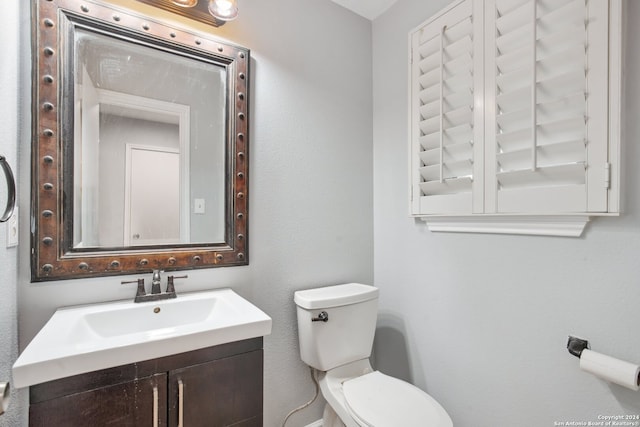 bathroom with toilet and vanity