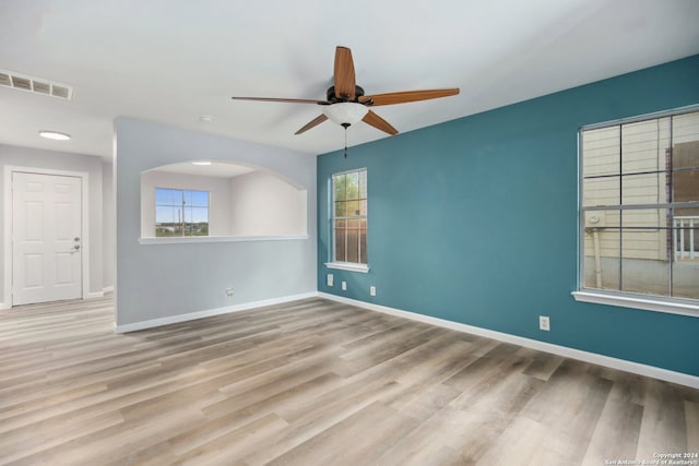 spare room featuring light hardwood / wood-style flooring and ceiling fan