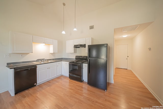 kitchen with white cabinets, sink, light hardwood / wood-style flooring, high vaulted ceiling, and black appliances