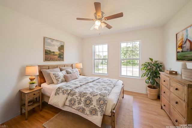 bedroom with ceiling fan and light hardwood / wood-style flooring