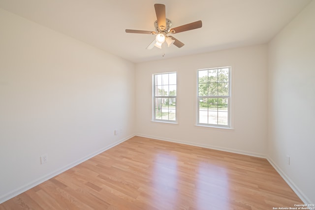 empty room with light wood-type flooring and ceiling fan