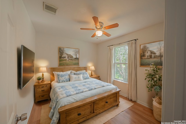 bedroom with ceiling fan and light hardwood / wood-style floors