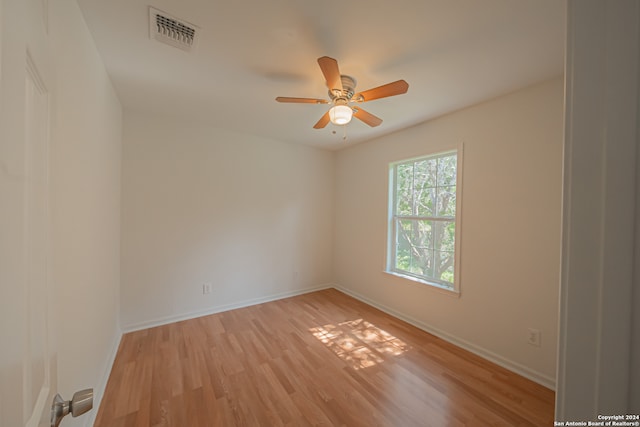 spare room featuring ceiling fan and light hardwood / wood-style flooring