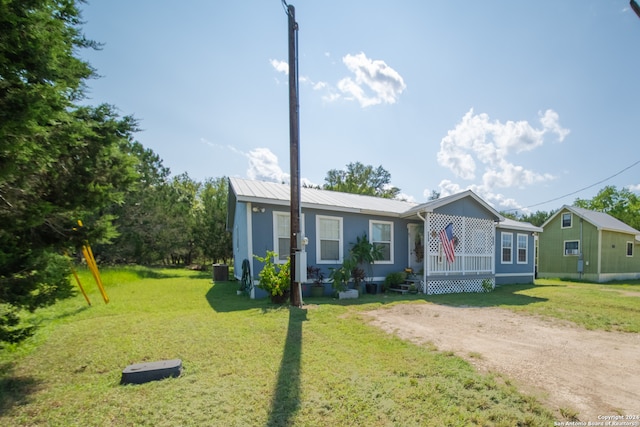 view of front of home featuring a front lawn and central AC unit