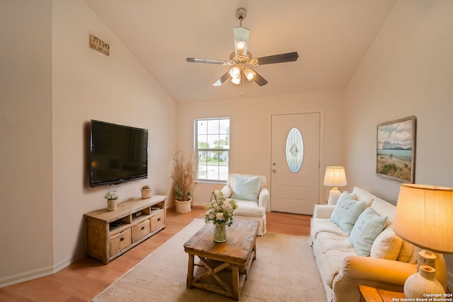 living room with ceiling fan, light hardwood / wood-style flooring, and high vaulted ceiling