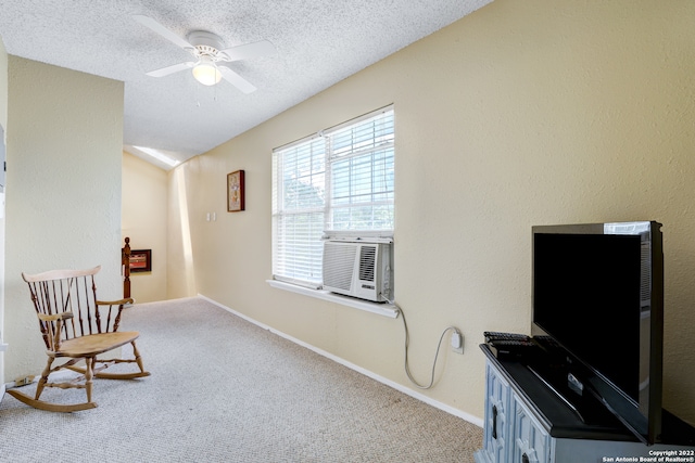 sitting room featuring a textured ceiling, cooling unit, light carpet, and ceiling fan