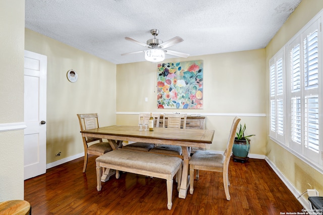 dining space with a textured ceiling, dark hardwood / wood-style floors, and ceiling fan