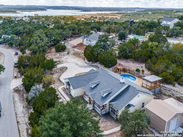 birds eye view of property with a water view