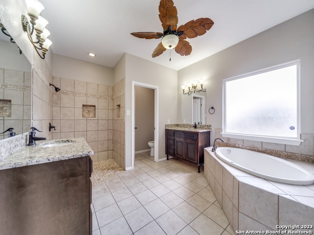 full bathroom with vanity, toilet, ceiling fan, and plus walk in shower