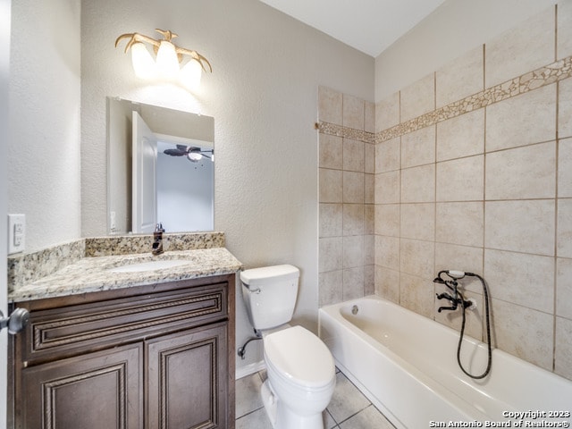 bathroom featuring ceiling fan, vanity, tile patterned flooring, and toilet